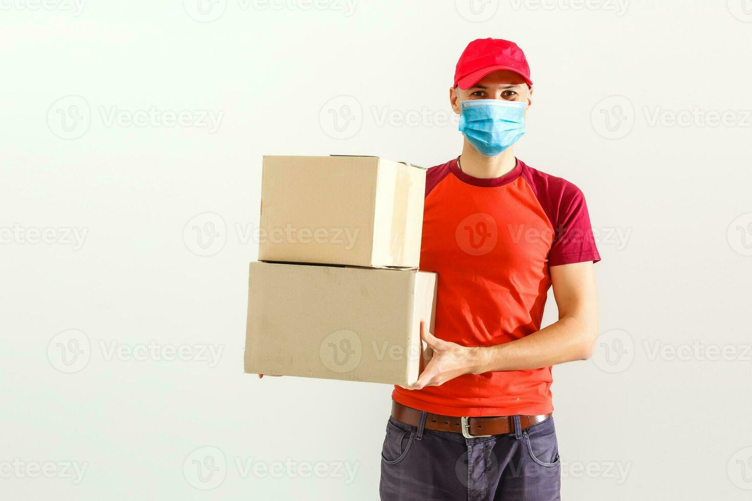 delivery man in protective mask with parcel post box isolated over white background. photo