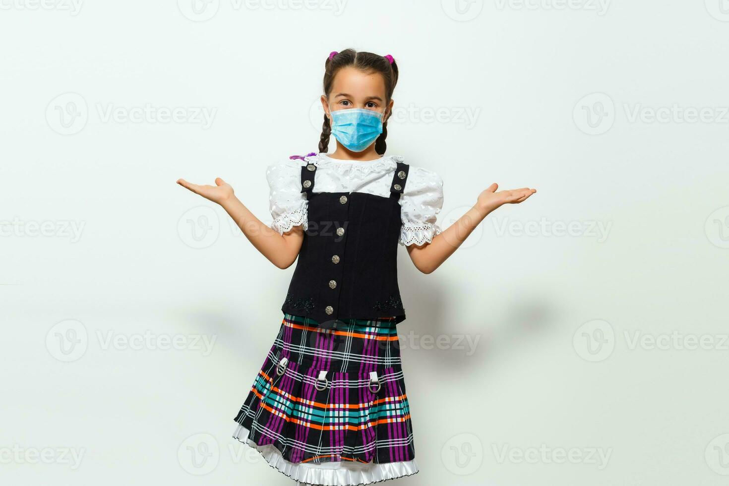 Masked child - protection against influenza virus. Little Caucasian girl wearing mask for protect pm2.5. baby on a gray background with copy space. epidemic, pandemic. photo