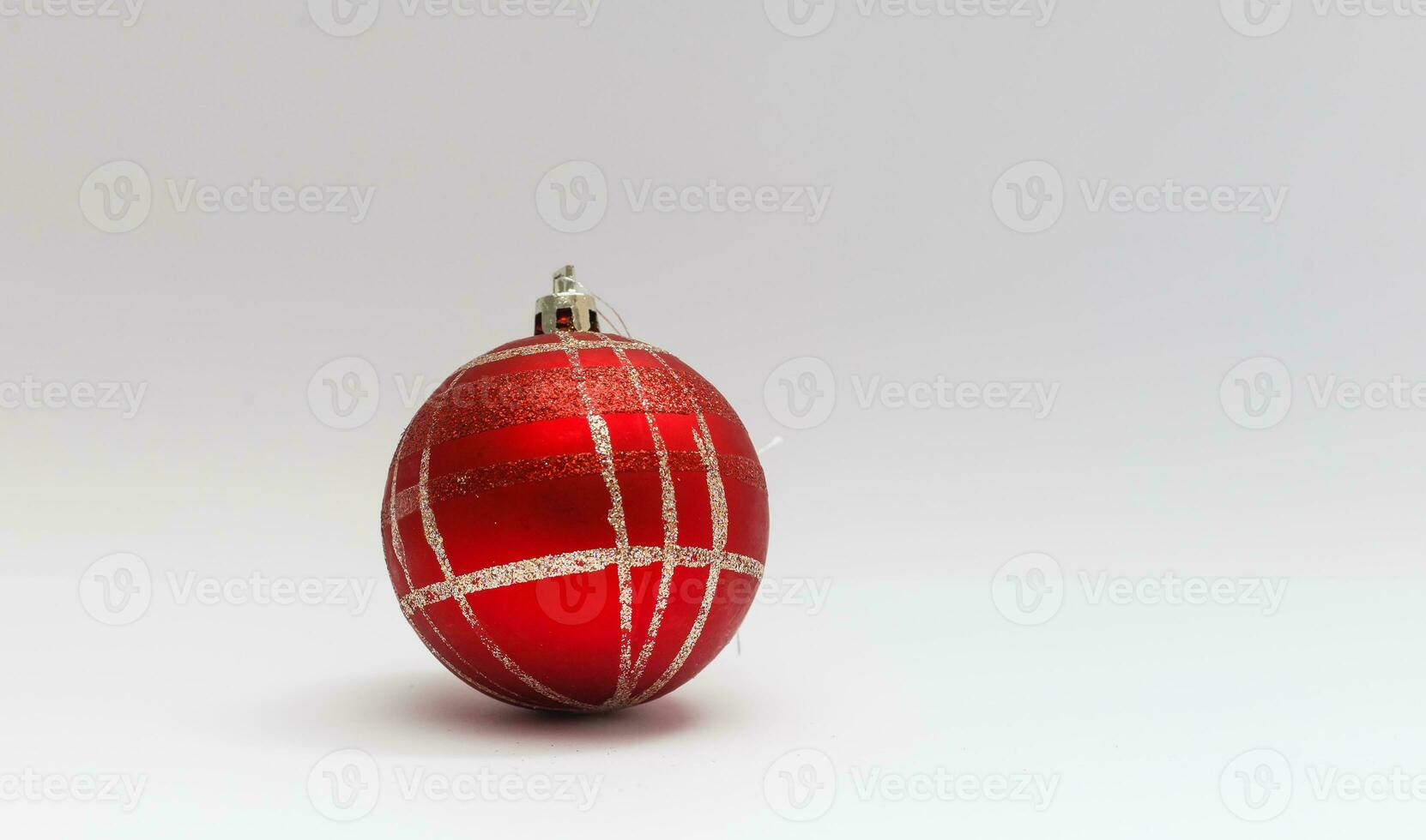 Single red Christmas tree ball decoration isolated over the white background, photo