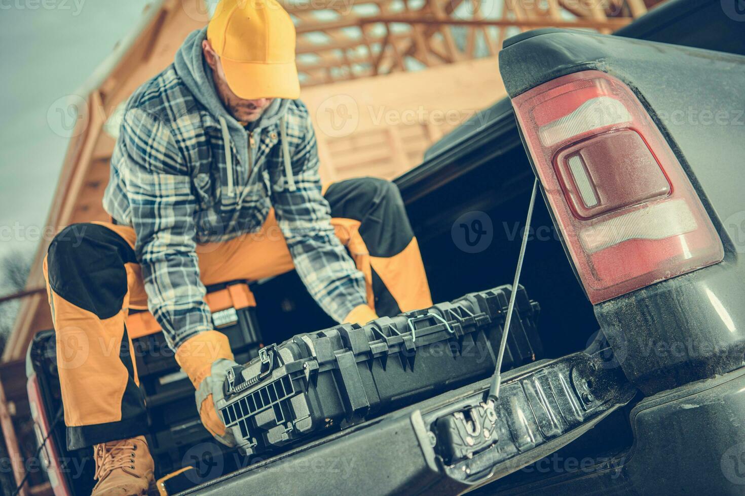Worker Preparing His Tools on the Pickup Cargo Section photo