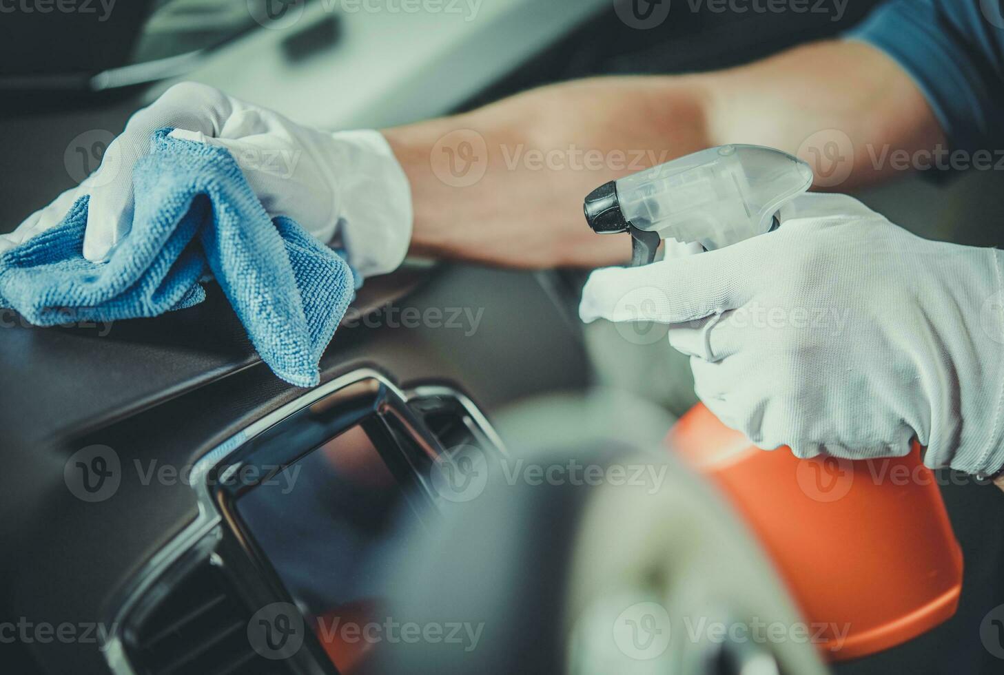 Worker Cleaning Car Dashboard photo