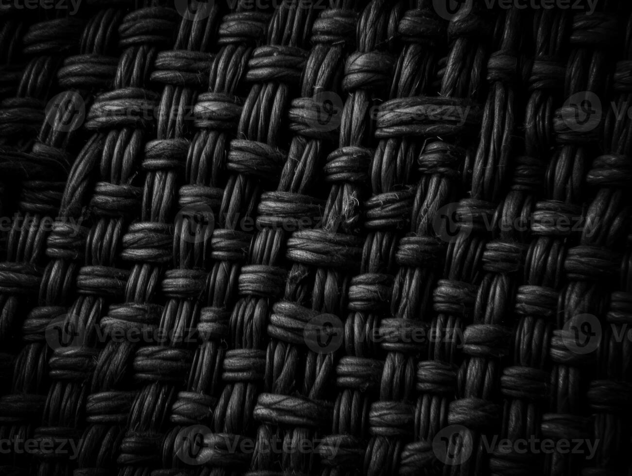 Dark black Abstract woven mat texture. Wickerwork background created with technology photo