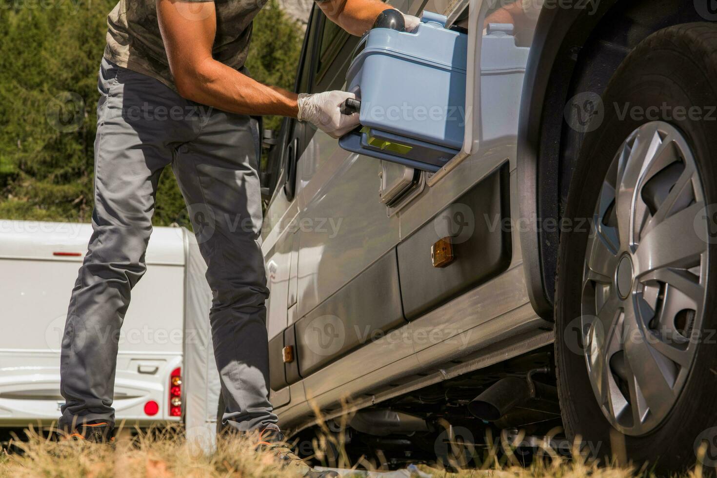 Men Removing Toilet Cassette From His Camper Van RV photo