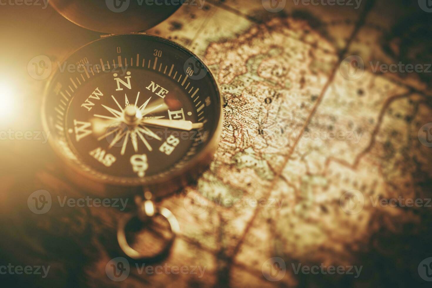 Compass and Paper Map Navigation Tools Closeup photo