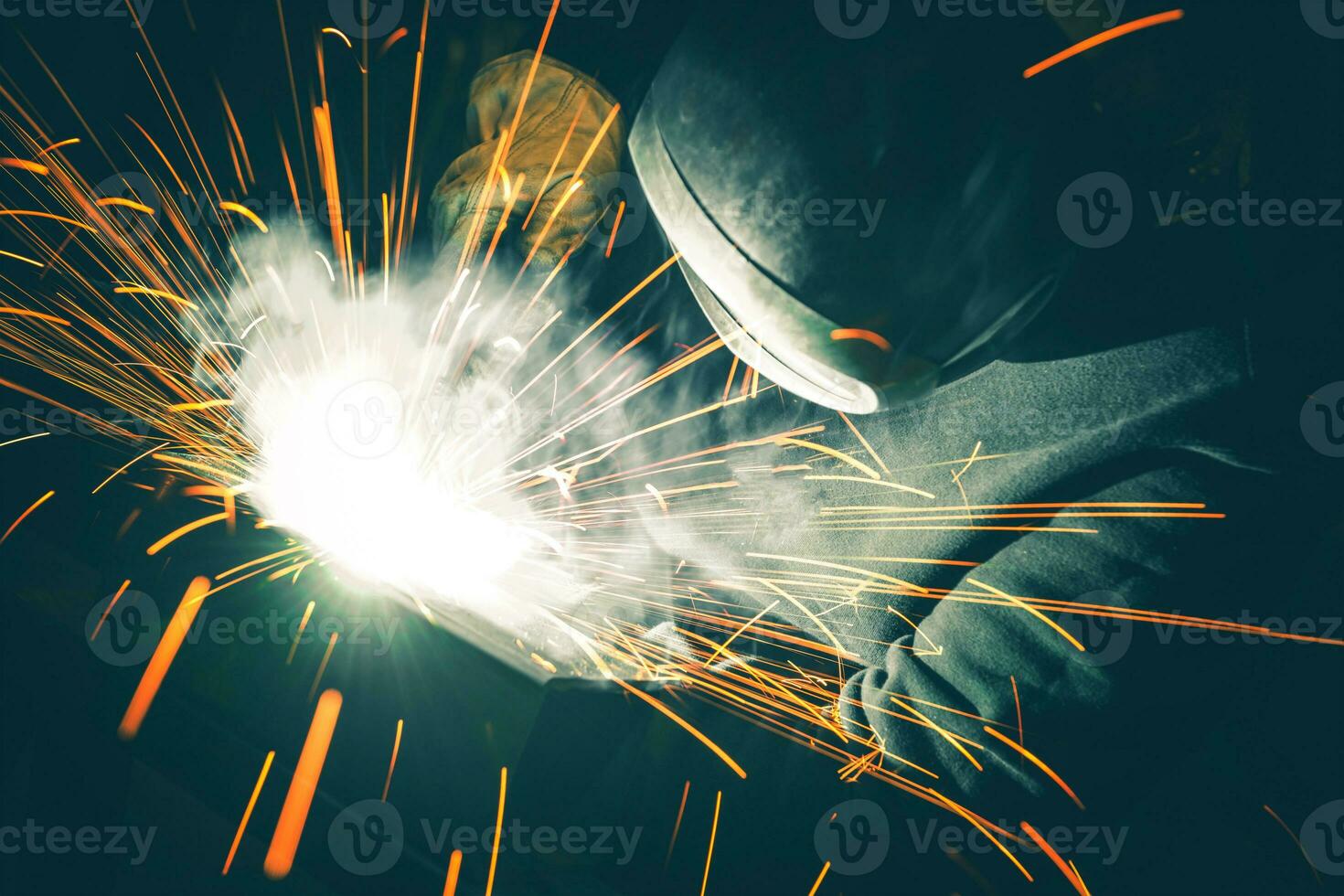 Welder is Welding Two Metal Parts Together photo