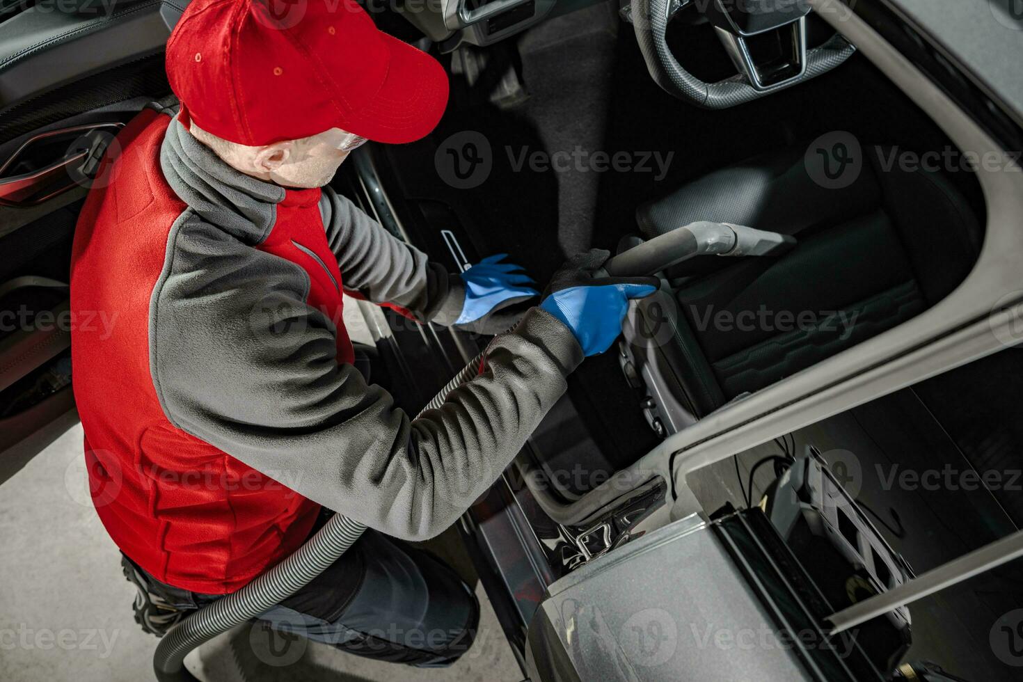 Automotive Service Worker Cleaning Car Interior photo