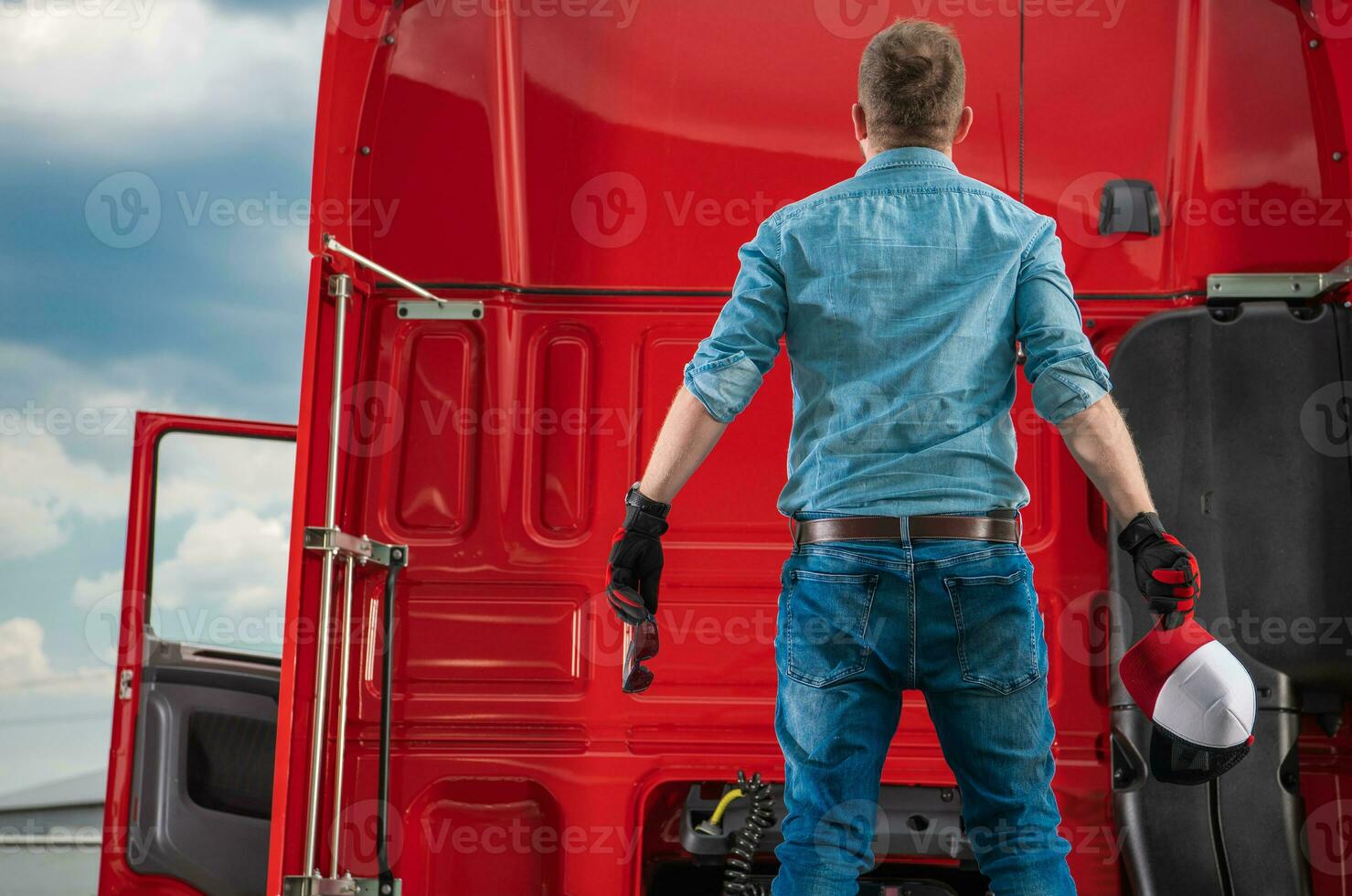 Surprised Semi Trucker Staying on Fifth Wheel of His Truck photo