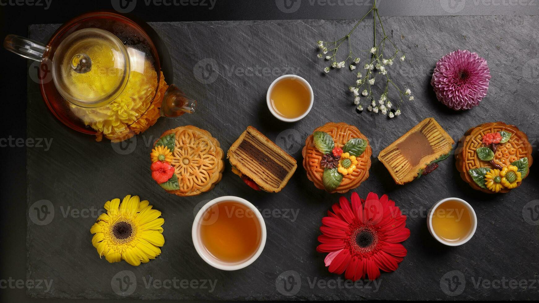 Colourful flower decorated mooncake Chinese mid autumn festival black slate stone background white teacup glass teapot daisy chrysanthemum mum rose baby breath flower red yellow pink purple violet photo