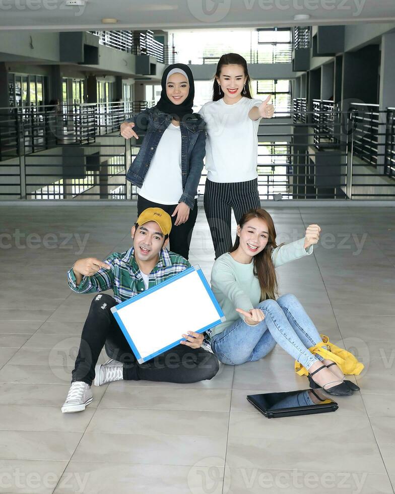 Young asian malay chinese man woman indoor stair corridor campus book file folder laptop computer phone sit stand study mingle photo
