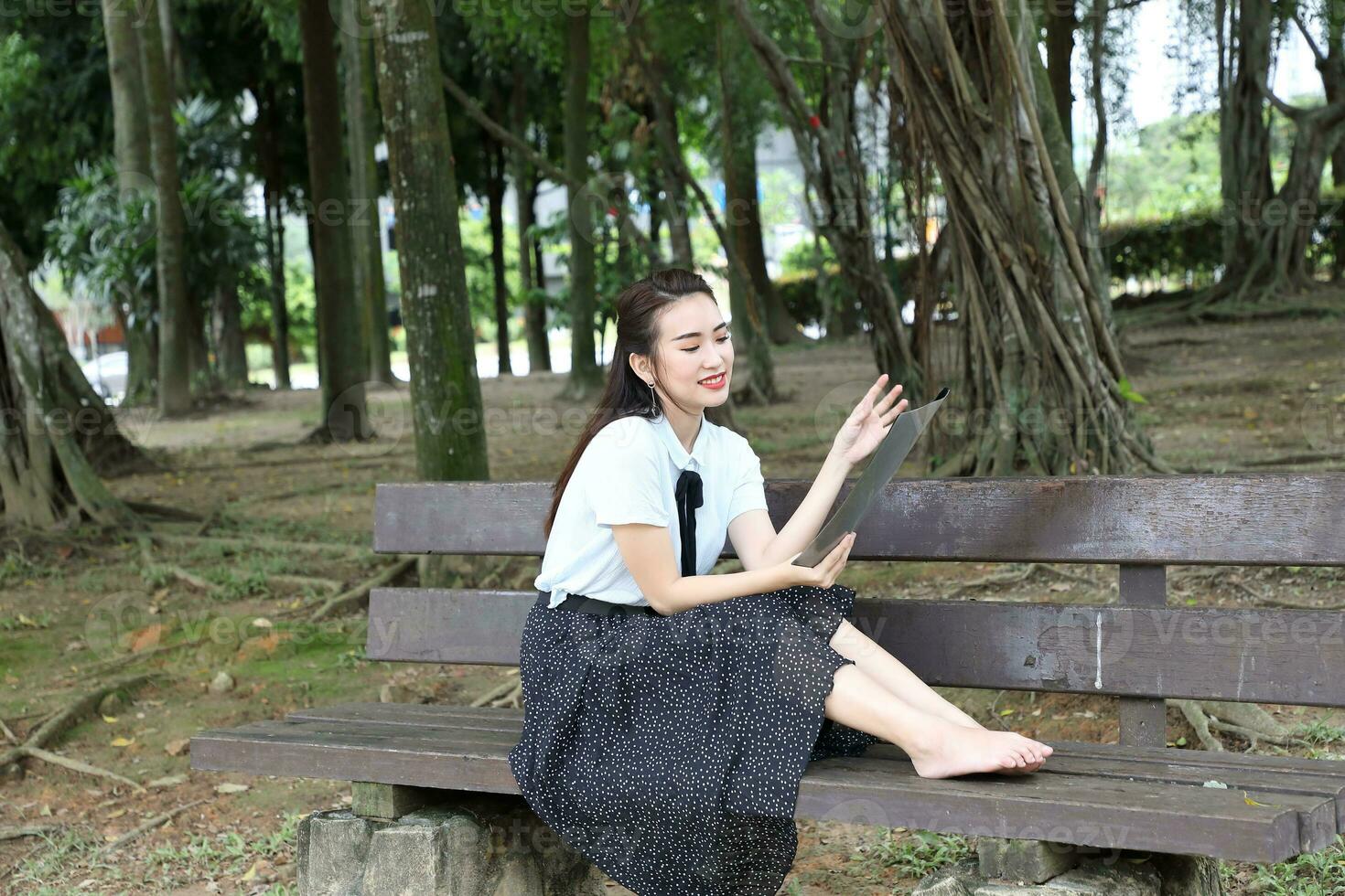 Young asian chinese woman outdoor park campus book file folder laptop computer phone sit stand study mingle photo
