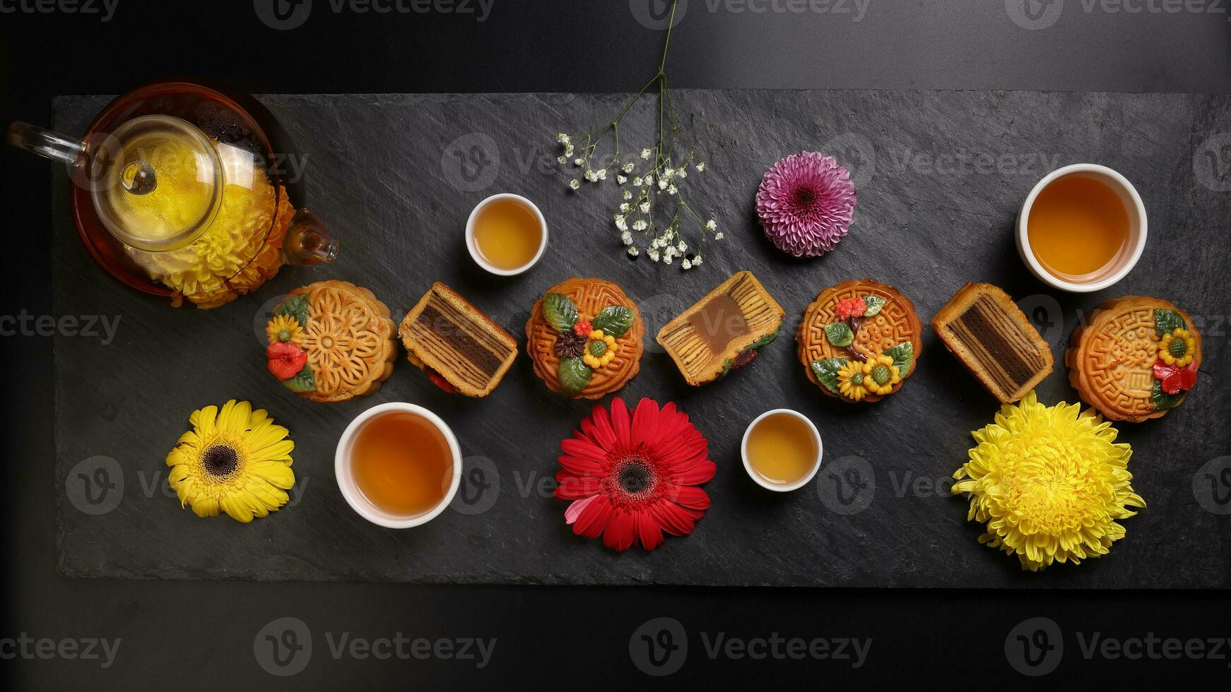 Colourful flower decorated mooncake Chinese mid autumn festival black slate stone background white teacup glass teapot daisy chrysanthemum mum rose baby breath flower red yellow pink purple violet photo