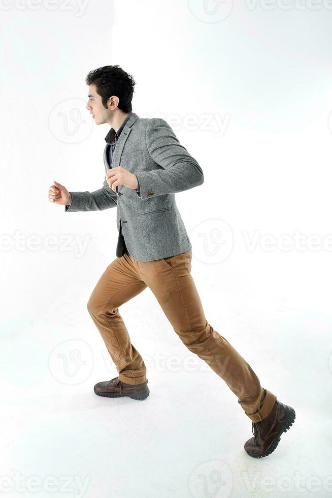 Middle eastern Caucasian young office business man wearing suit pose run sprint on white studio background photo