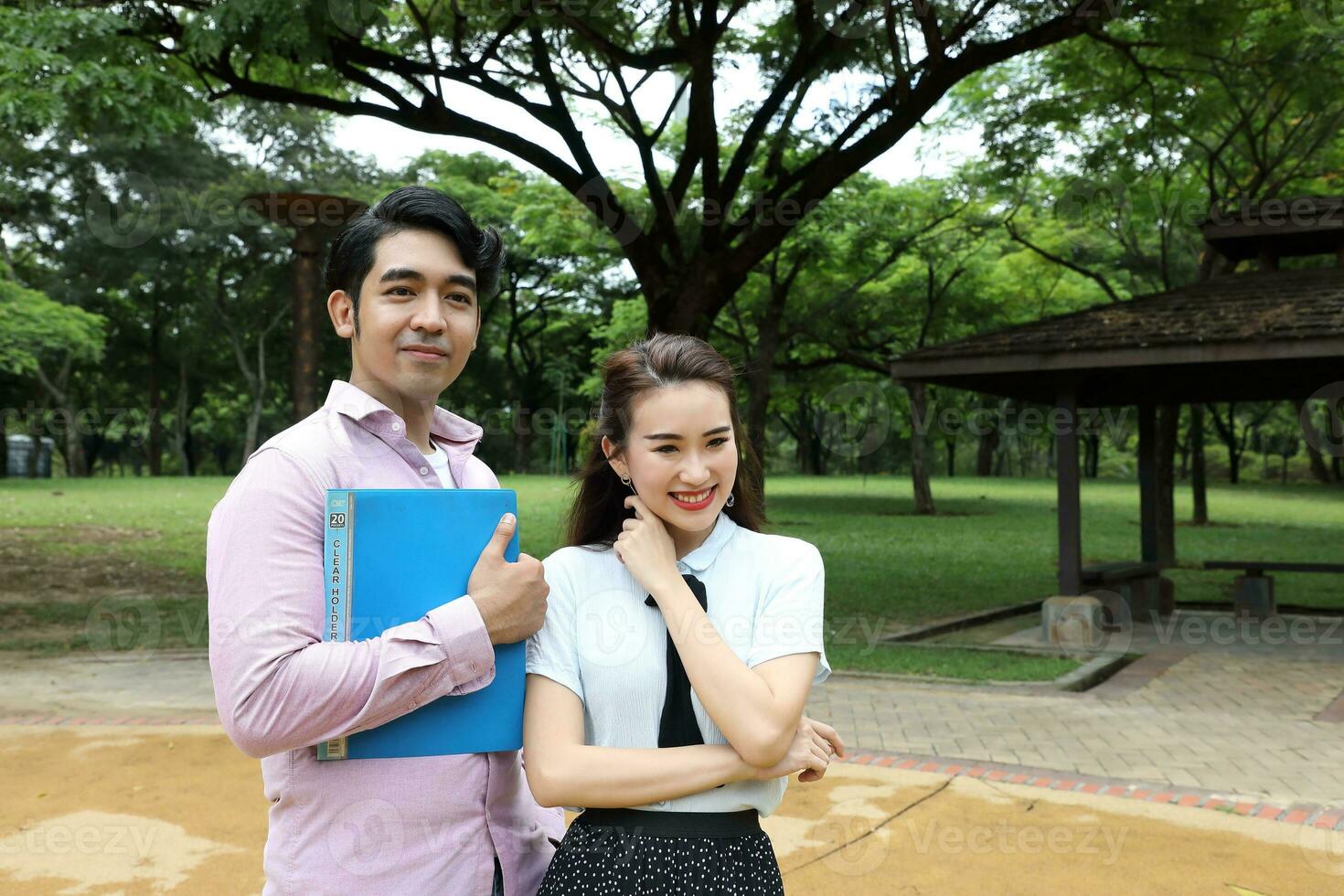 Young asian malay chinese man woman outdoor park  book file folder laptop computer phone sit stand study mingle photo