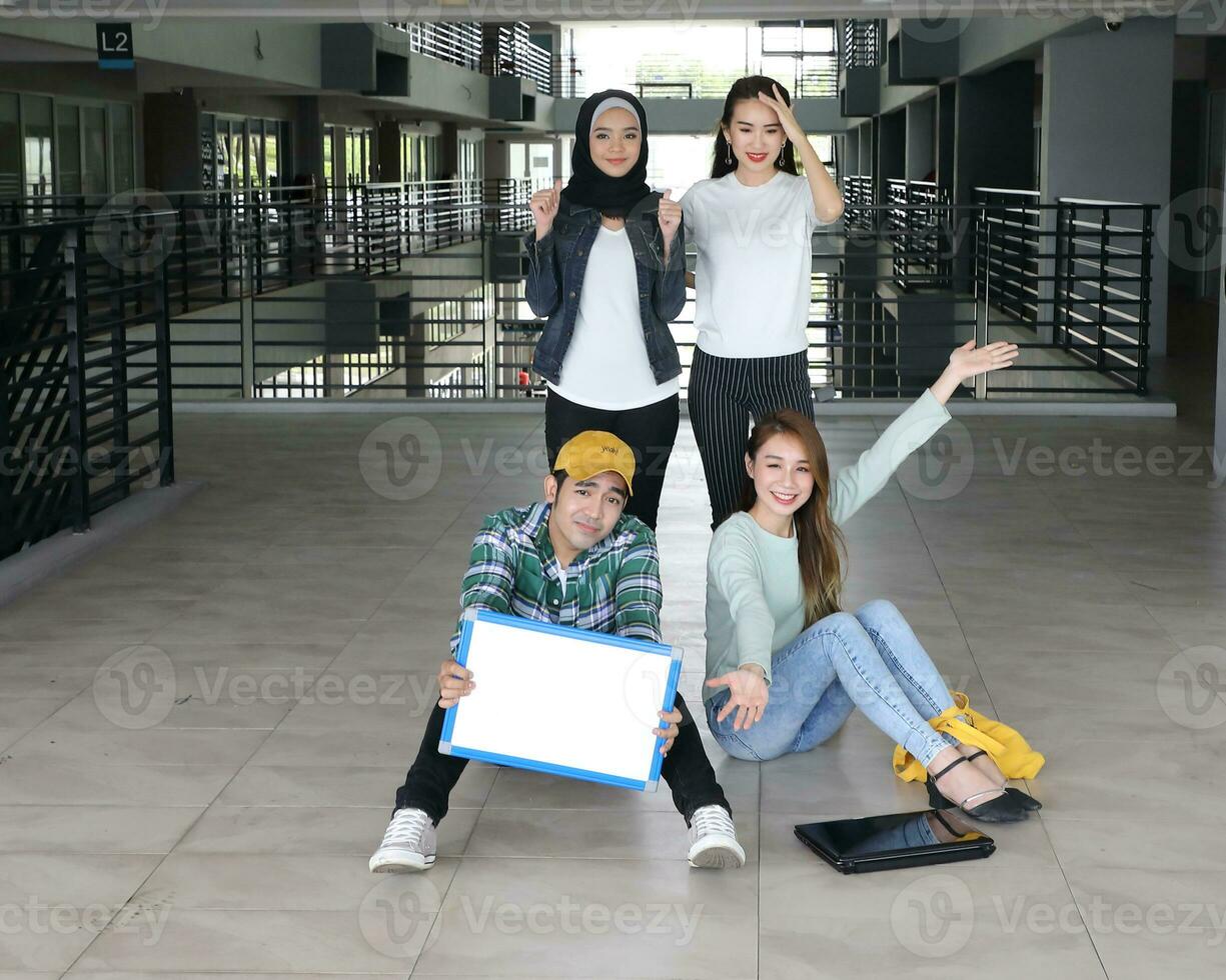 Young asian malay chinese man woman indoor stair corridor campus book file folder laptop computer phone sit stand study mingle photo