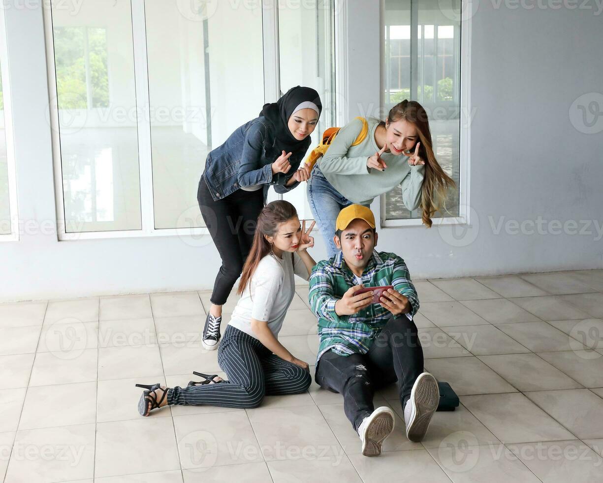 Young asian malay chinese man woman indoor stair corridor campus book file folder laptop computer phone sit stand study mingle happy selfie photo