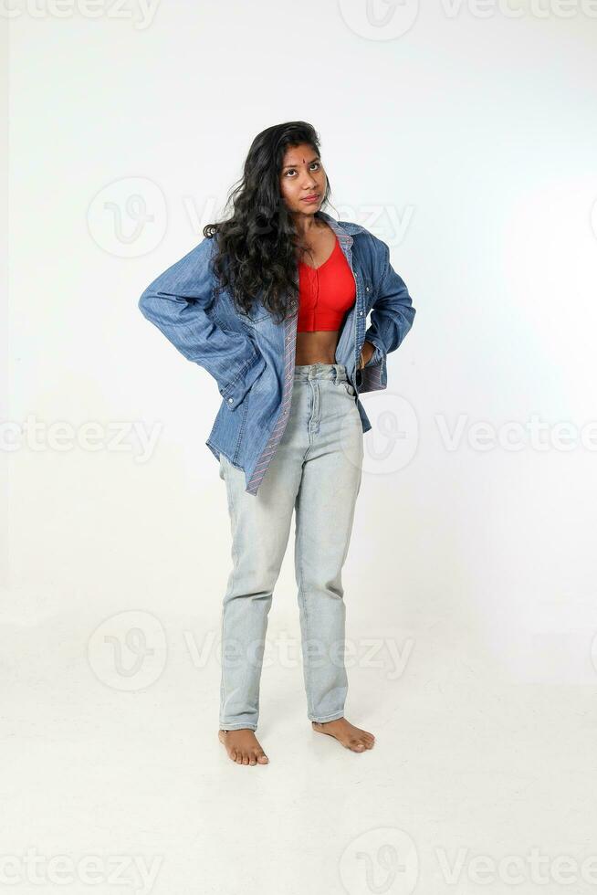 Young attractive Asian Indian woman pose face body expression mode emotion on white background wonder question what if angry upset photo