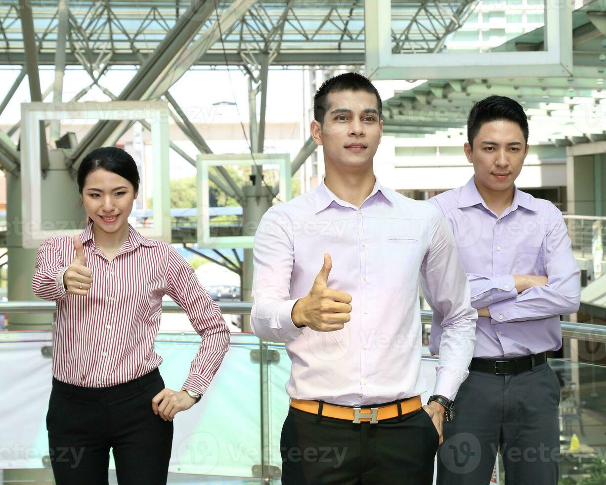 Young south east Asian middle eastern man woman business colleague outdoor stand pose photo