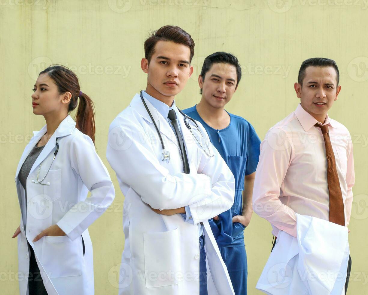 South East Asian young Malay Chinese man woman medical doctor stethoscope apron group stand pose confident look forward photo