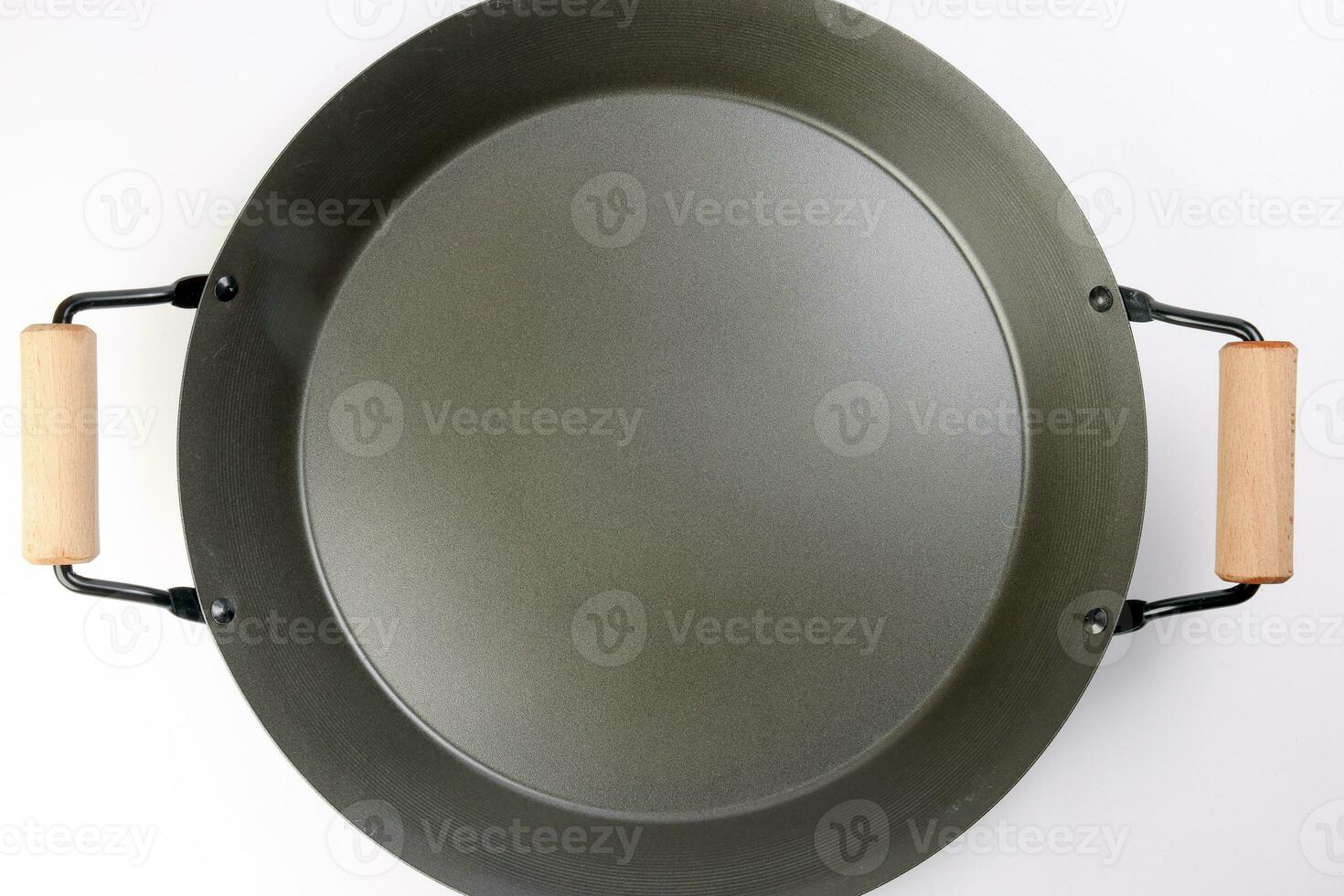 Cast metal not stick two wooden handle empty flat bottom frying pan on white background photo