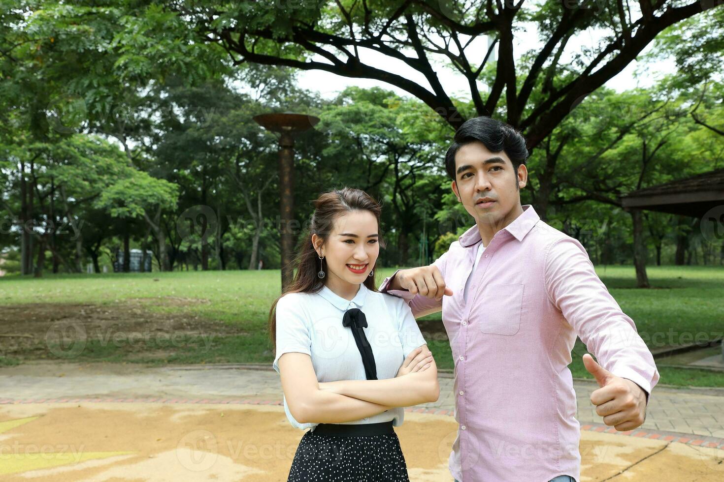 Young asian malay chinese man woman outdoor park  book file folder laptop computer phone sit stand study mingle photo