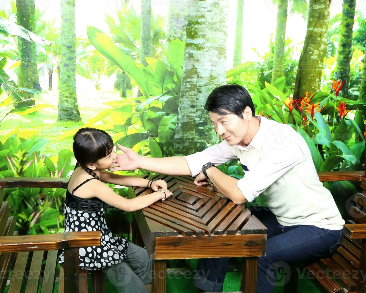 South East Asian young father mother daughter  parent girl child activity indoor photo