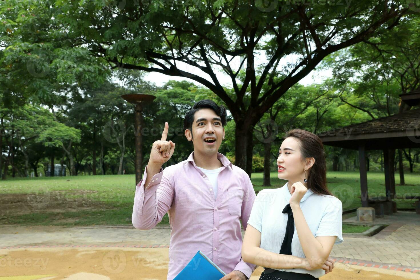 young asian malay chinese man woman outdoor park walk stand study talk discuss laptop file book backpack pose happy mingle idea photo