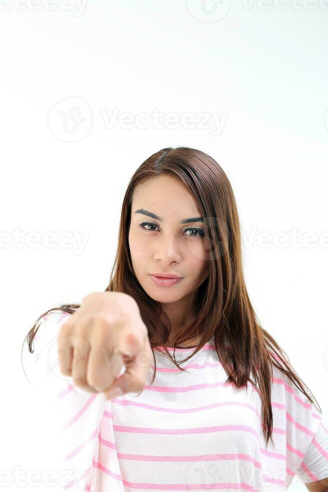 Yong Asian youth girl in casual dress point finger at camera on white background photo