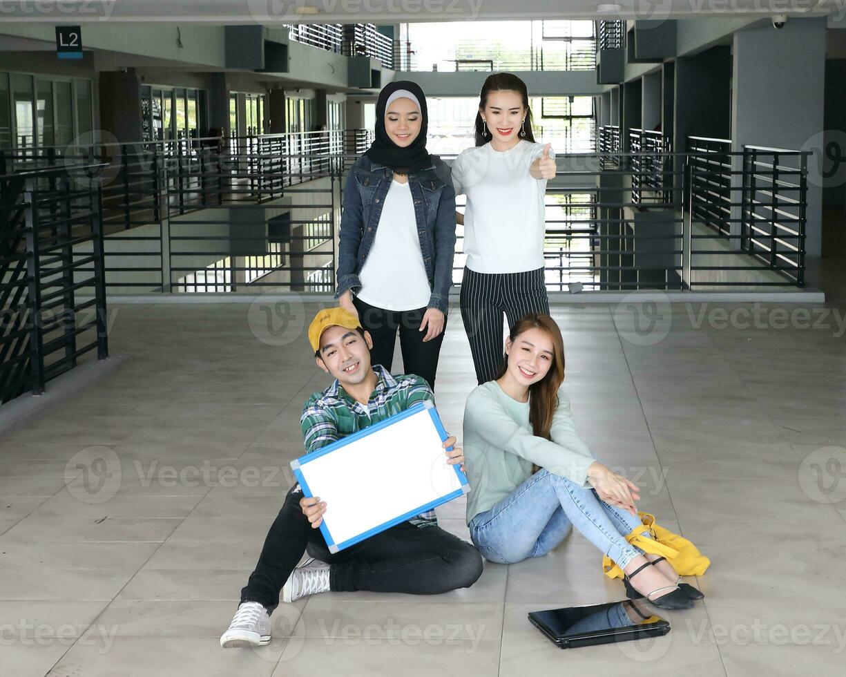 Young asian malay chinese man woman indoor stair corridor campus book file folder laptop computer phone sit stand study mingle photo
