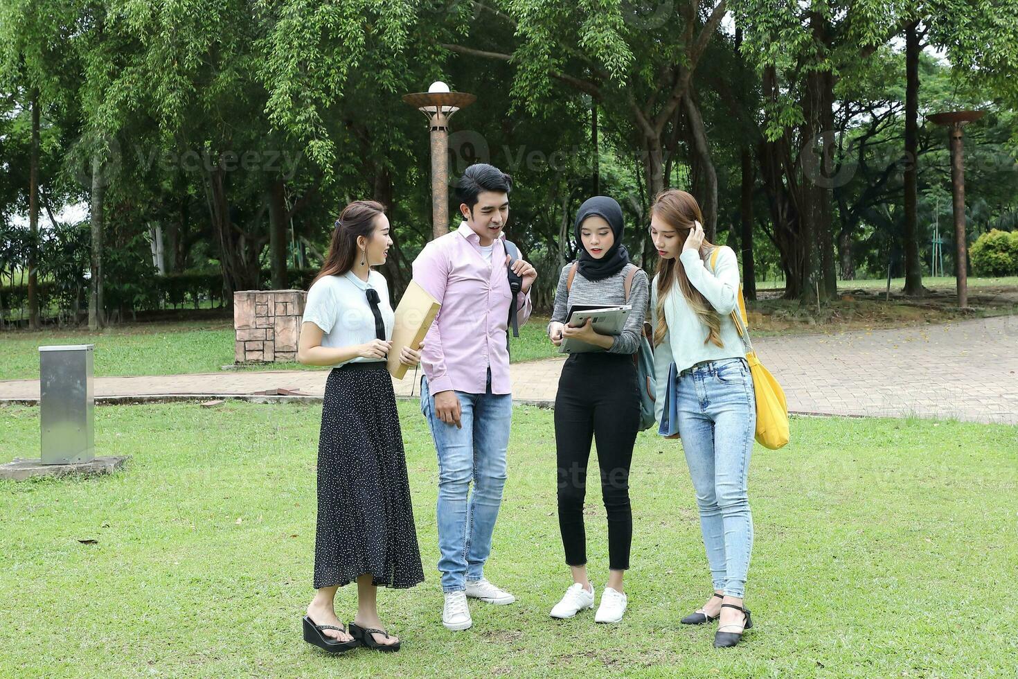 Young asian malay chinese man woman outdoor park  book file folder laptop computer phone sit stand study mingle photo