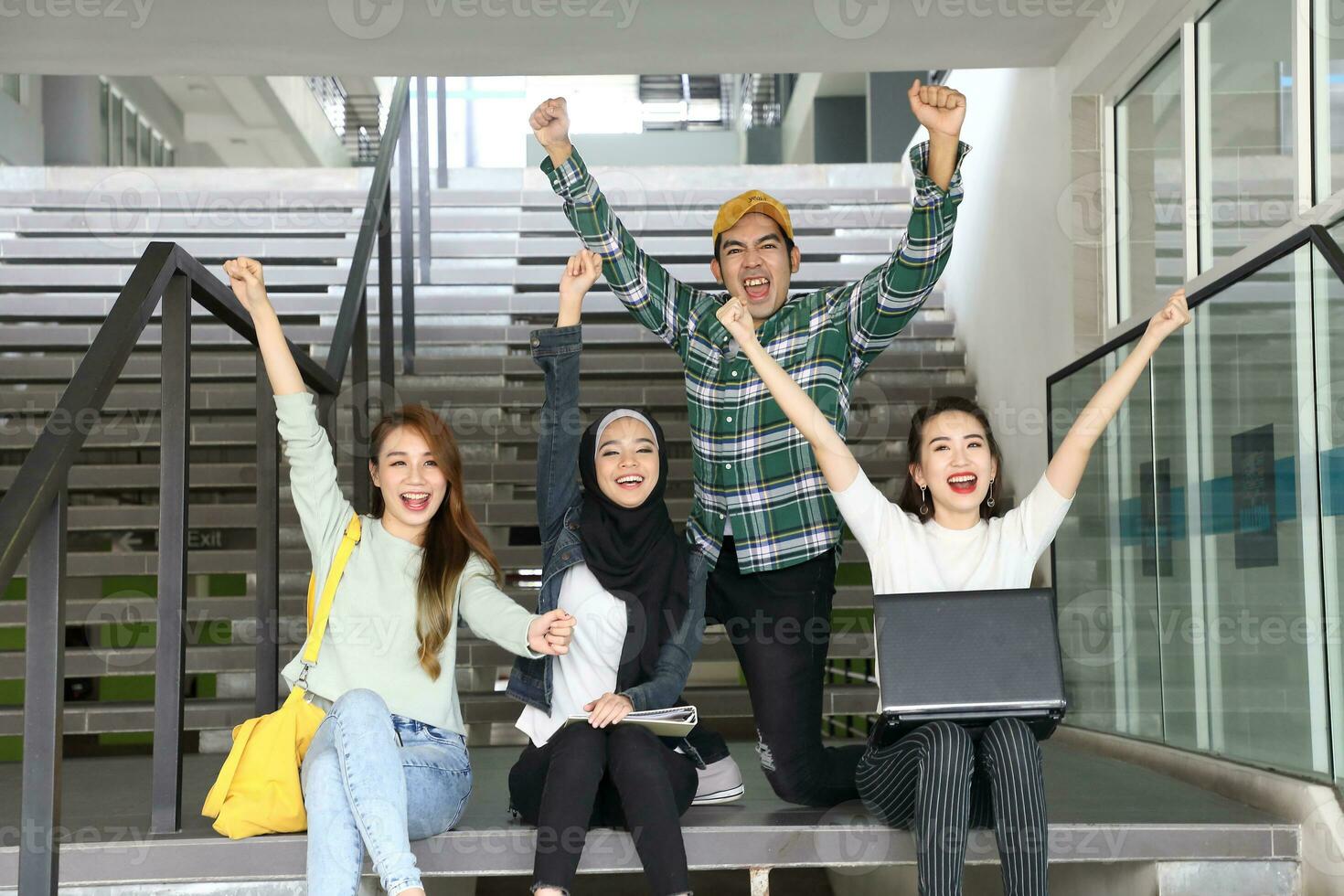 Young asian malay chinese man woman indoor stair corridor campus book file folder laptop computer phone sit stand study mingle photo