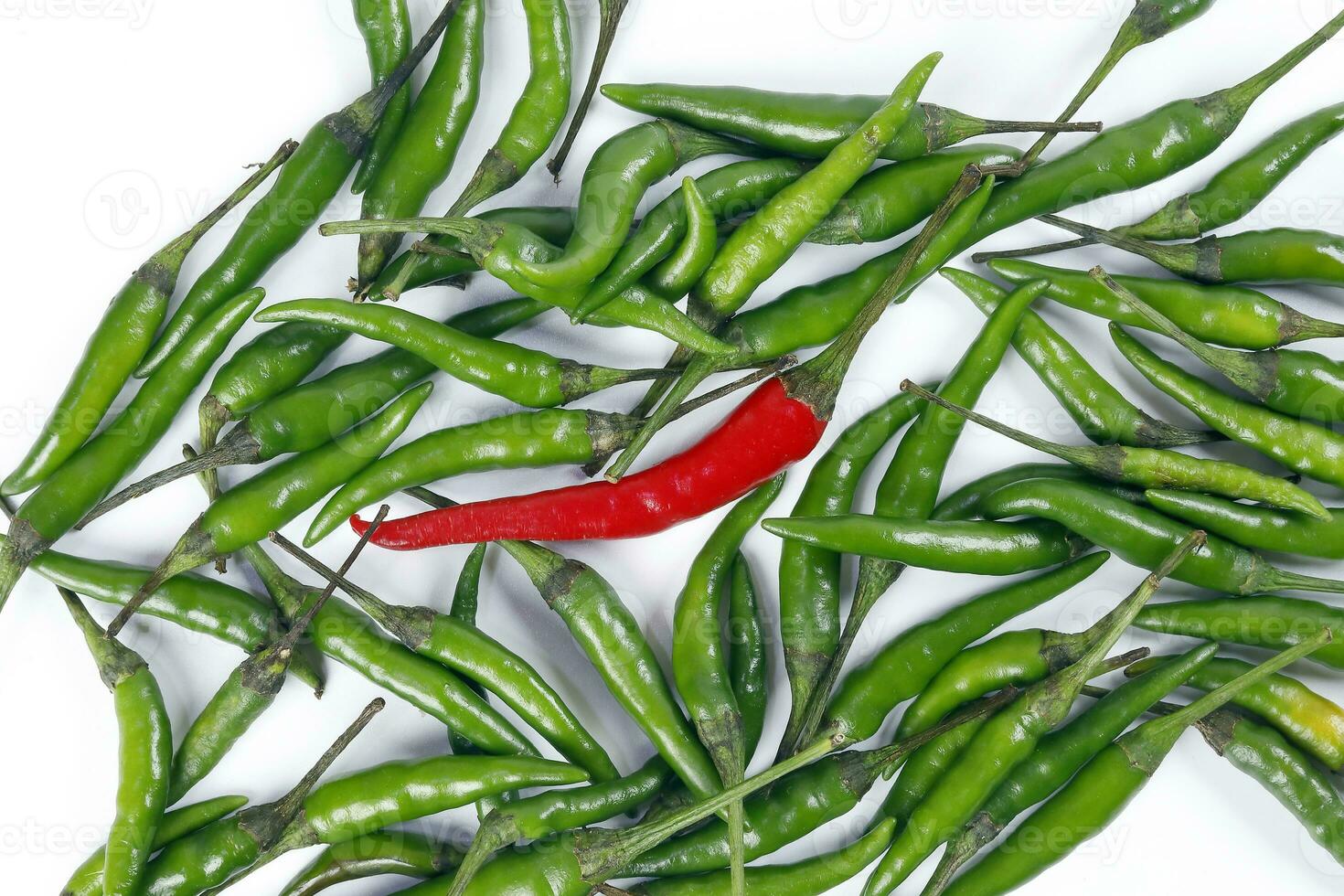 Fresh birds eye green chilli scattered isolated unique red chilli top view on white background photo