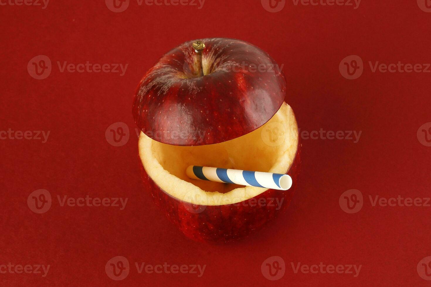 Health Red Cut Apple recyclable paper straw juice drink idea concept on red background photo