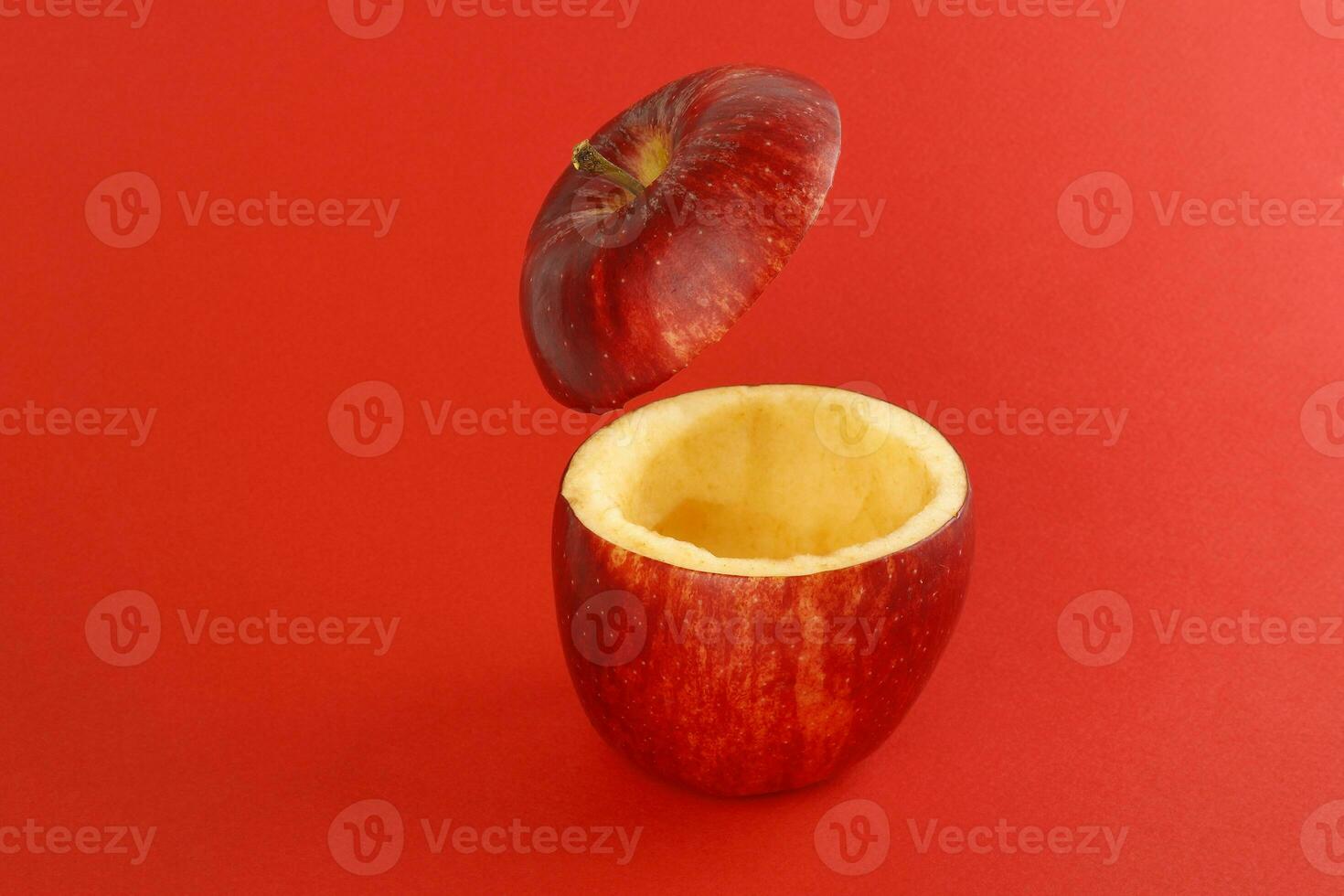 Healthy Red Cut Apple floating top slice juice drink idea concept on red background photo