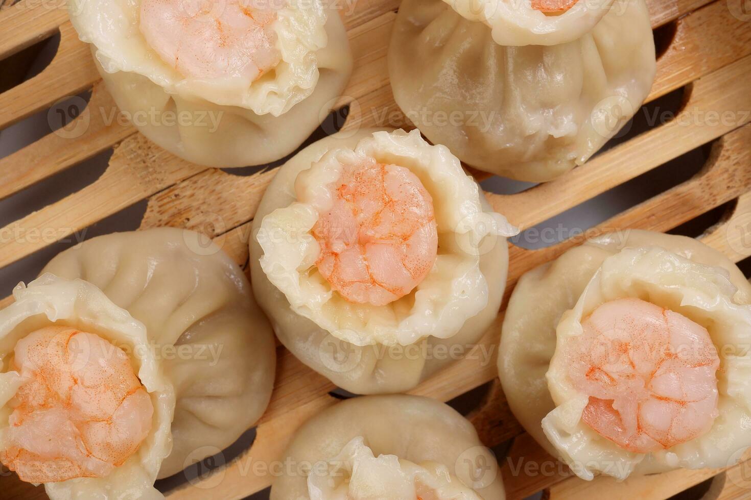 Prawn shrimp shaomai dim sum dumpling in bamboo steamer on white background photo