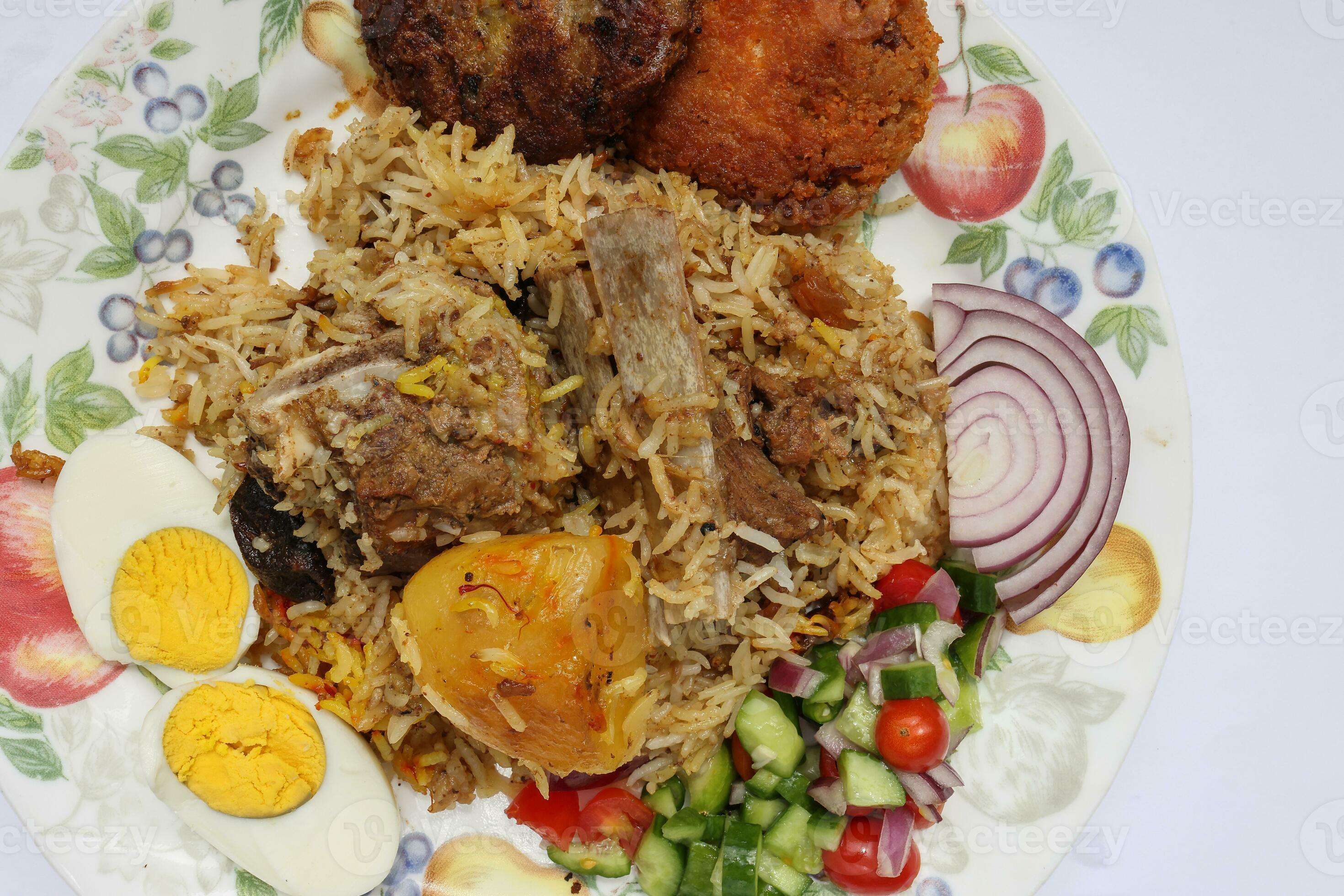 Home style mutton kacchi biryani with potato chop tomato cucumber onion