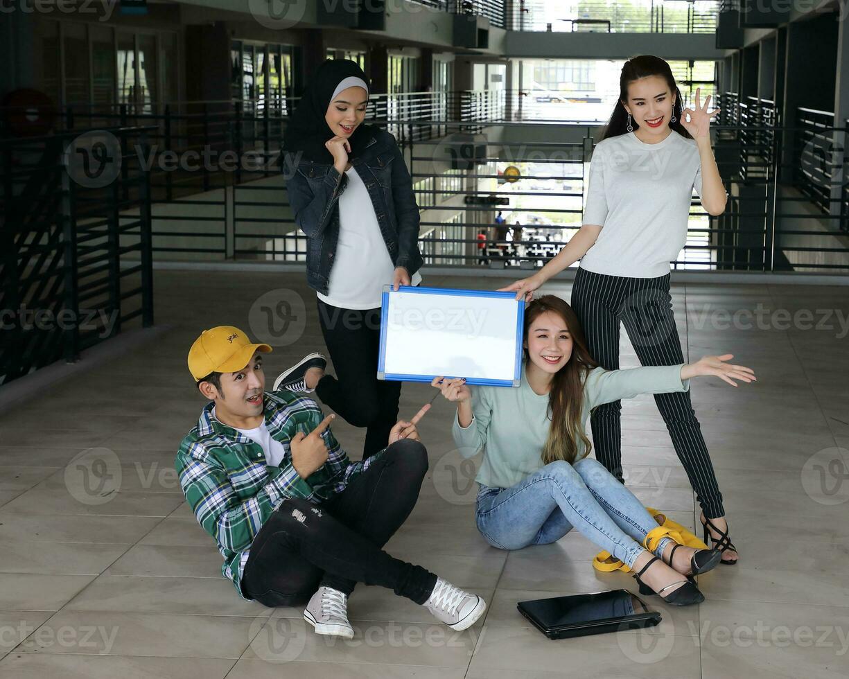 Young asian malay chinese man woman indoor stair corridor campus book file folder laptop computer phone sit stand study mingle photo