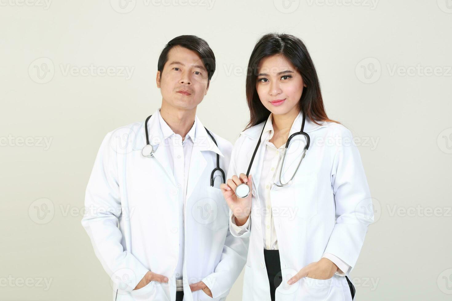 Young Asian male female doctor wearing apron uniform tunic apron hold photo