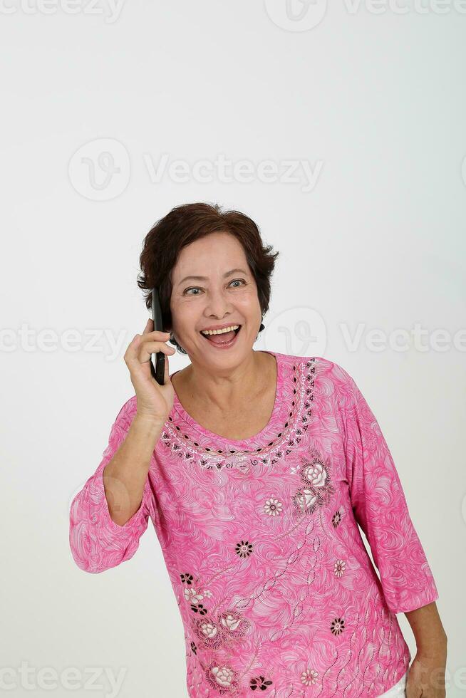 Elderly asian Chinese female on white background talking on phone happy joy smile photo