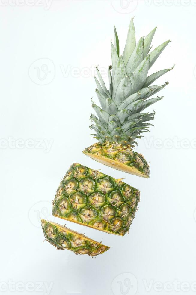 Pineapple whole rough skin slice chopped flying elevated photo