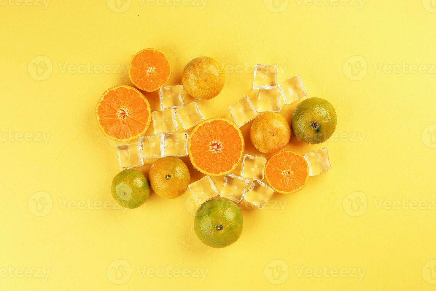 small yellow green mandarin ice cube orange whole slice on yellow background copy space for text photo