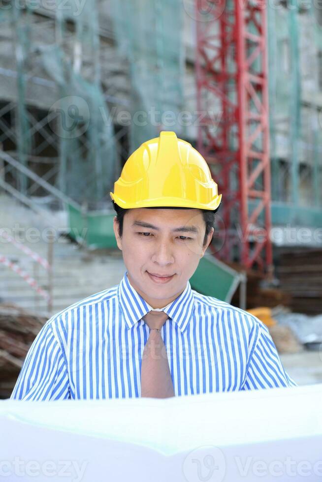 South East Asian young Malay Chinese man woman wearing safely helmet construction site work photo