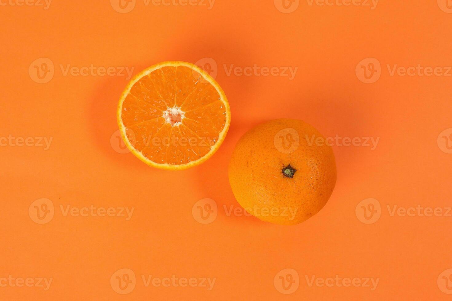 Mandarin Orange Fruit slice half on orange background photo
