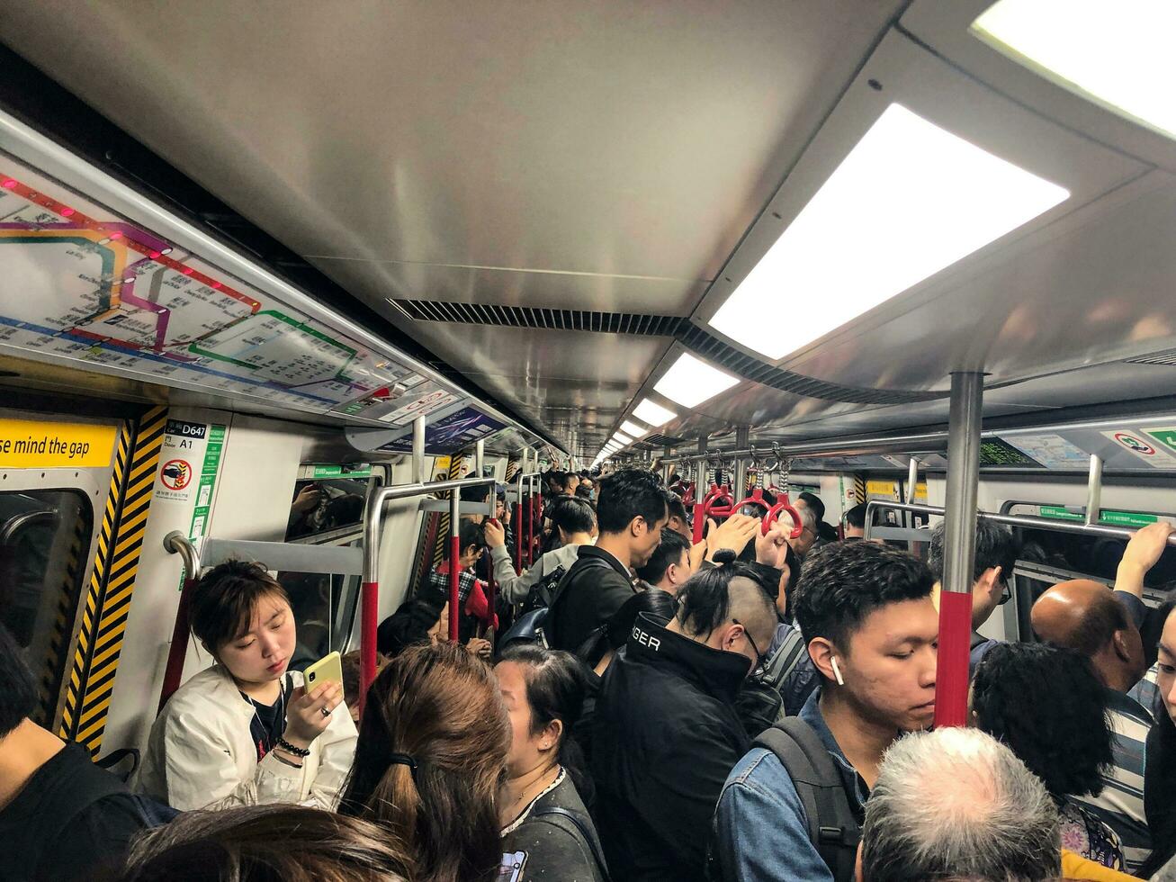 Hong Kong- May 19, 2019 The Mass Transit Railway or MTR is a major public transport network serving Hong Kong. Crowded rush hour. photo