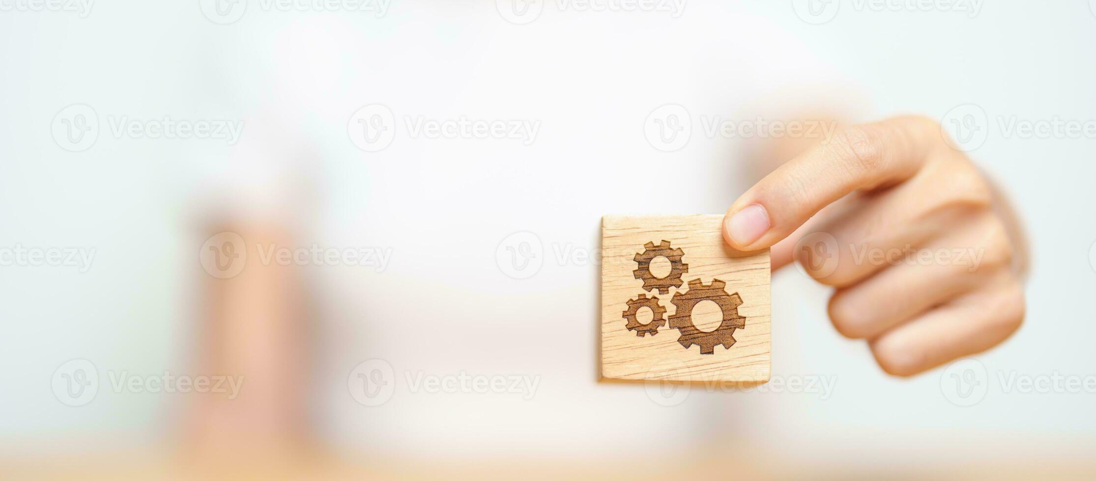 hand hold gear block with business goal, strategy, teamwork, target, mission, action, objective, brainstorming  and success concept photo