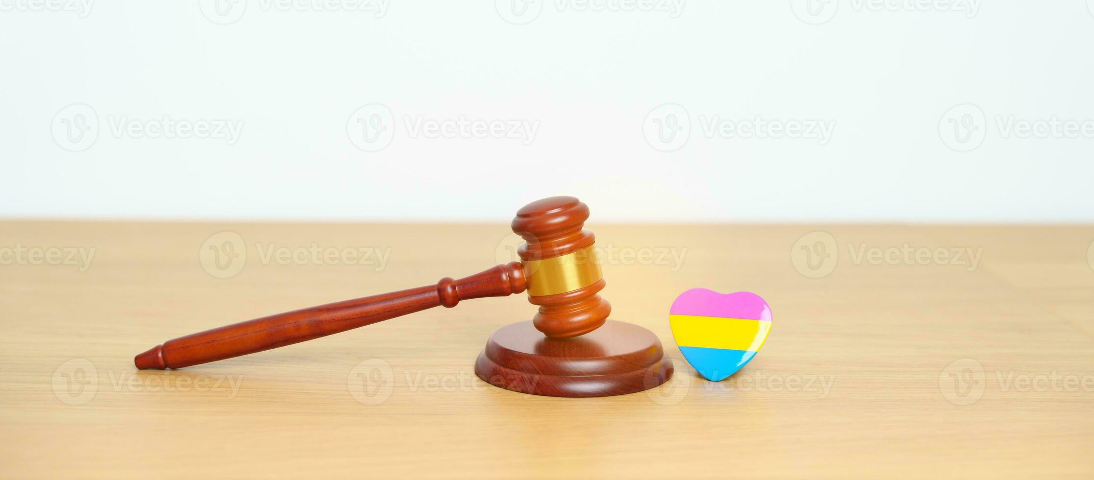 Pansexual Pride Day, LGBTQ Law and Pride month concepts. gavel justice hammer with pink, yellow and blue heart shape for Lesbian, Gay, Bisexual, Transgender, Queer, Intersex photo