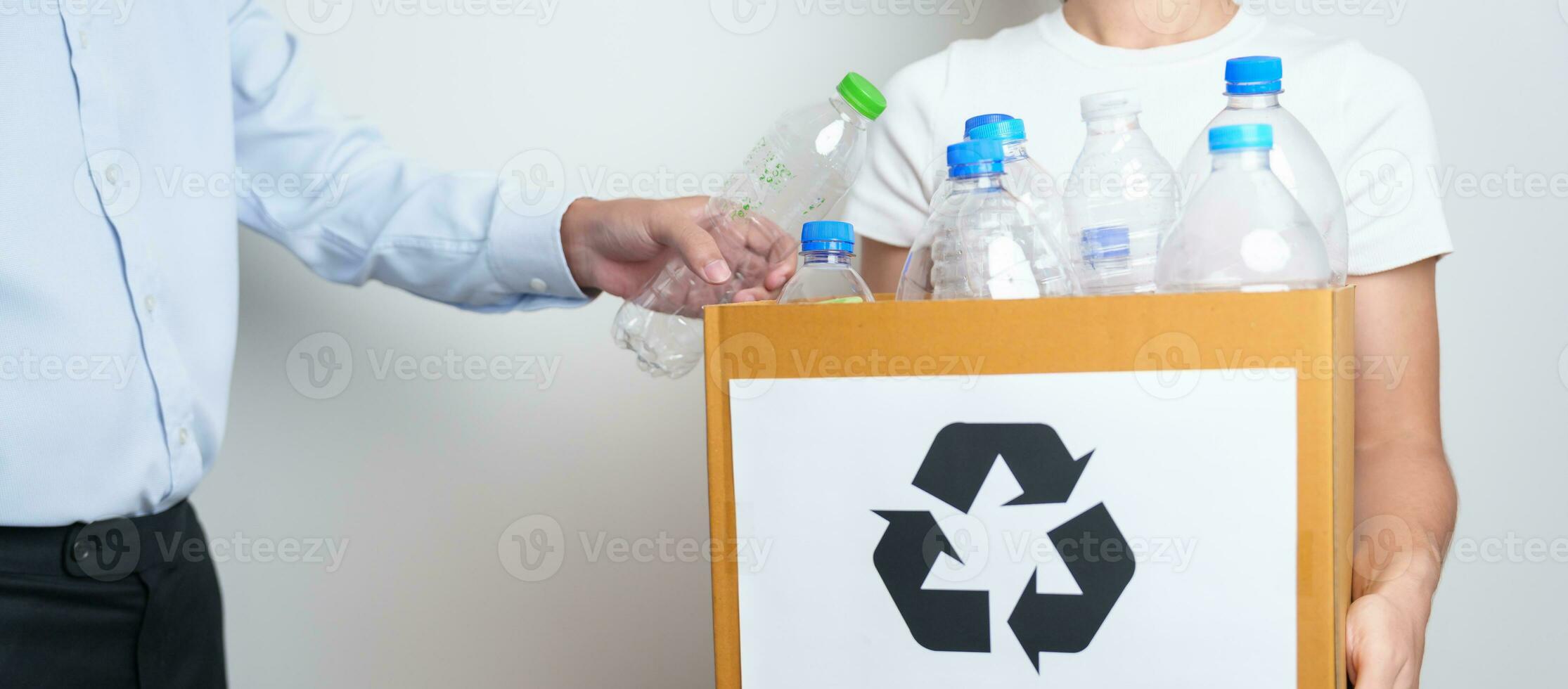 Volunteer keep plastic bottle into paper box at home or office. Hand Sorting Recycle garbage. Ecology, Environmental, pollution, Dispose recycling, waste management and trash Separation concept photo