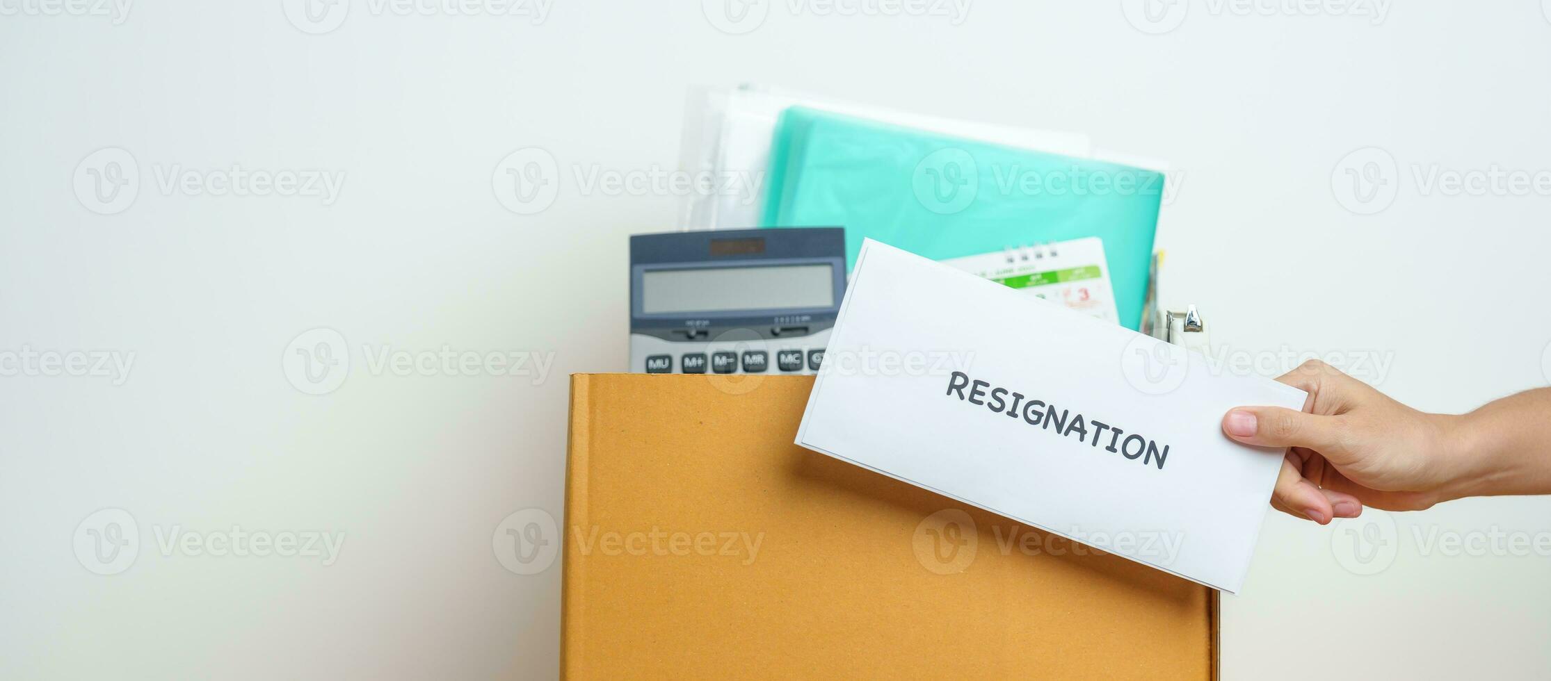 Resignation, Layoff, Unemployment, Dismiss, Job quit, Jobless and Farewell concept. Businesswoman holding letter of Resign contract with documents cardboard box at office photo