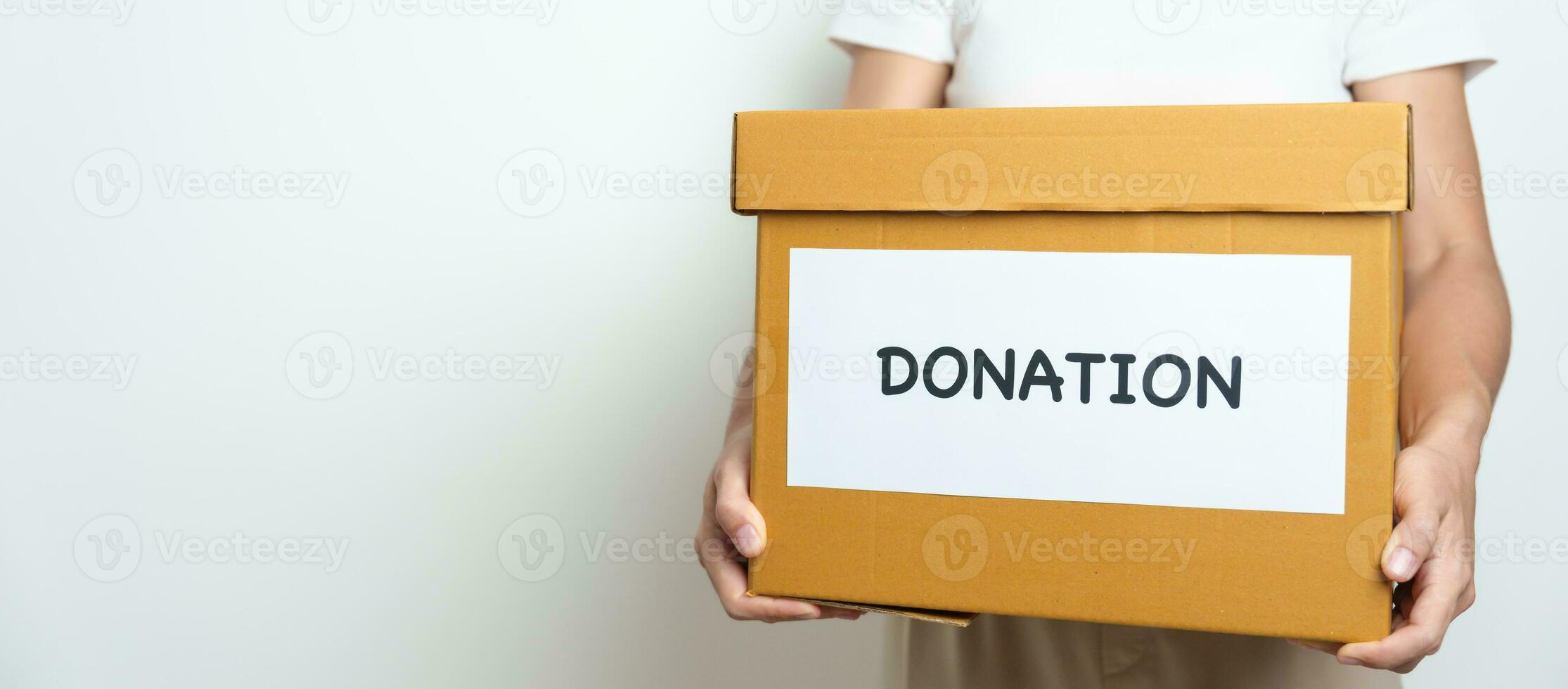 Donation, Charity, Volunteer, Giving and Delivery Concept. People donate Clothes and Food into Donation box at home or office for support and help poor, refugee and homeless people. Copy space photo