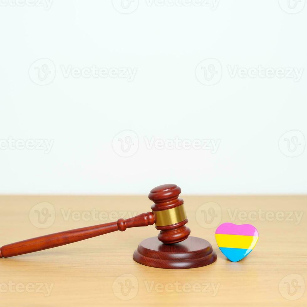 Pansexual Pride Day, LGBTQ Law and Pride month concepts. gavel justice hammer with pink, yellow and blue heart shape for Lesbian, Gay, Bisexual, Transgender, Queer, Intersex photo