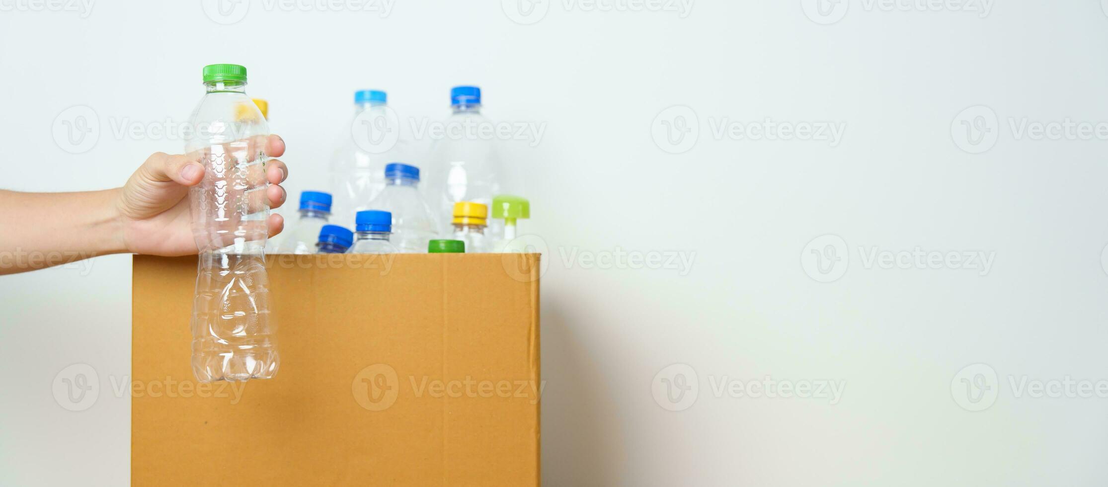 Volunteer keep plastic bottle into paper box at home or office. Hand Sorting Recycle garbage. Ecology, Environmental, pollution, Dispose recycling, waste management and trash Separation concept photo